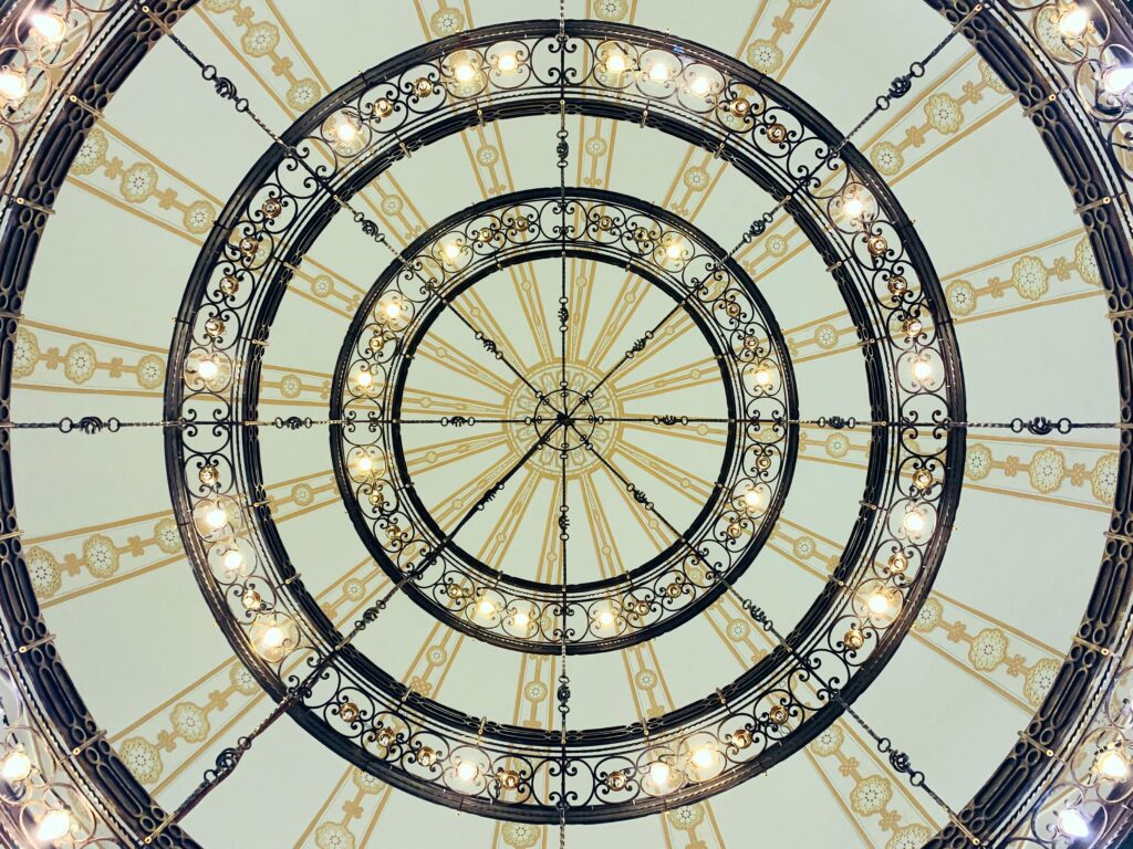 Circular chandelier with ornate design in a Jeddah interior, illuminating the space.